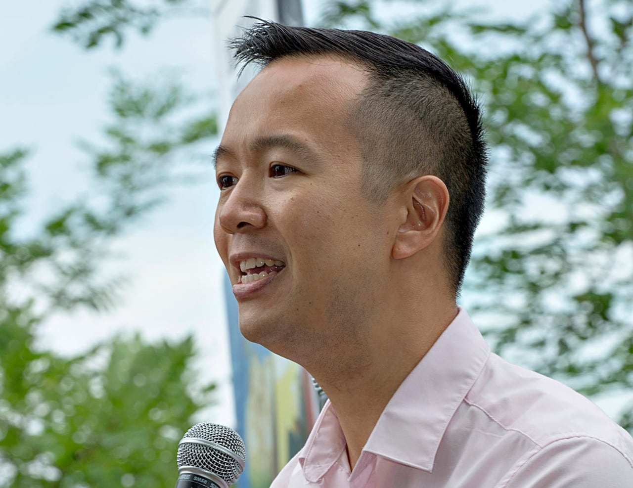 A man speaks into a microphone
