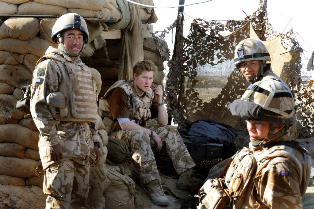 Several soldiers sit at an observation post.